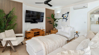 St. Peter's Bay 204 living room TV corner with slatted wood panels and a wooden media unit, Barbados
