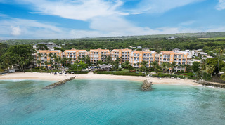 Aerial of arched peach buildings above a white-sand beach at the St. Peter's Bay 207 resort, apartments in Barbados