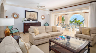 Glass-topped coffee table with a woven shelf amid cream sofas, St. Peter's Bay 308, holiday apartment in Barbados