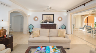 Loveseat in front of a sideboard flanked by sunburst mirrors and turquoise quatrefoil chairs, St. Peter's Bay 308, Barbados