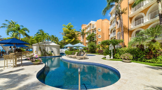 Communal pool grab rail and parasols, white balconies on apricot facades, St. Peter's Bay 308 near Speightstown, Barbados