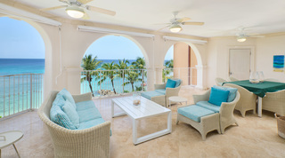 Three ceiling fans over woven seating and a green-clothed dining table, St. Peter's Bay 401, beach apartment in Barbados