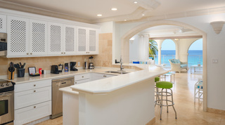 Lattice cupboards and a breakfast bar with an arch view to the sea, St. Peter's Bay 401 apartment rental, Barbados
