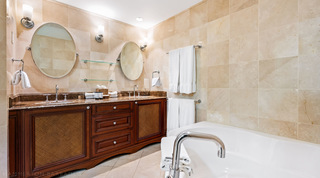 Long twin vanity with three drawers, oval mirrors and glass shelves, St. Peter's Bay 404 apartment rental in Barbados