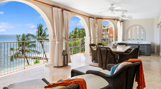 Hot tub and woven dining chairs on the arched terrace overlooking the sea, St. Peter's Bay 404 luxury apartment, Barbados