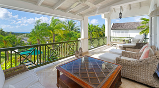 Woven armchairs and a sea view on the balcony of Sugar Cane Ridge 2 – Coral Blu, a Royal Westmoreland villa in Barbados