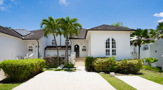 White facade, palm trees and steps to the arched entrance of Sugar Cane Ridge 21 – Ruby Blue, private villa in Barbados