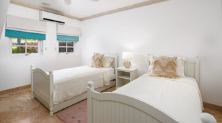 Twin bedroom with white panelled beds and teal-trimmed blinds at Sugar Cane Ridge 21 – Ruby Blue in St. James, Barbados