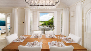 Dining table for six with the terrace and golf course beyond at Sugar Cane Ridge 21 – Ruby Blue, Barbados villa