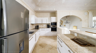 Granite worktops and a stainless fridge-freezer in the kitchen at Sugar Cane Ridge 21 – Ruby Blue, a Barbados villa rental