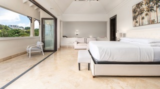 Vaulted ceiling, tufted headboard and palm painting in the master suite, Tree House Villa 5, Barbados