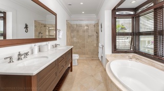 Twin basins, walk-in shower and oval bath in the en suite bathroom at Tree House Villa 5, Barbados