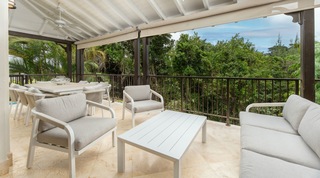 Covered terrace set for dining above the tree canopy at Tree House Villa 5 in St. James, Barbados