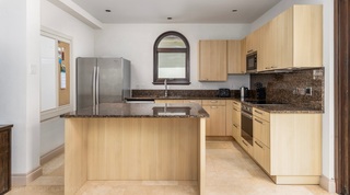 Kitchen with granite worktops, pale wood cabinetry and an arched window, Tree House Villa 5, Barbados