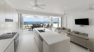 White kitchen island opening to the living space and ocean, Westmoreland Hills 25, villa in Barbados