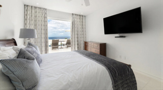 Queen bedroom with terrace access and ocean view at Westmoreland Hills 25, St. James, Barbados