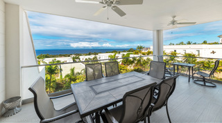 Terrace dining table beneath ceiling fans at Westmoreland Hills 25 with panoramic sea views, Barbados