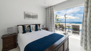 King bedroom opening to the pool terrace and ocean at Westmoreland Hills 25, St. James, Barbados