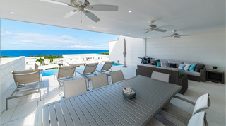 Covered terrace dining and lounge at Westmoreland Hills 25 with views to the sea, Barbados