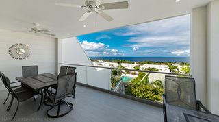 Covered terrace dining with sunburst mirror and panoramic sea views, Westmoreland Hills 25, luxury villa Barbados