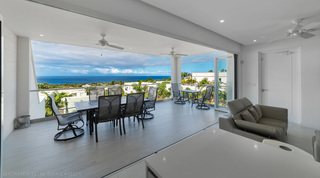 Living room opening to the covered terrace and ocean at Westmoreland Hills 25, St. James, Barbados