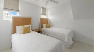 Twin bedroom at Westmoreland Hills 25 with rattan headboards and roman blinds, Barbados